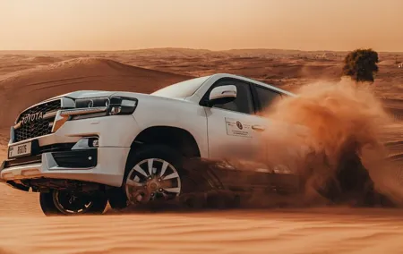 Deluxe Sunset Desert Safari: SandSurfing, Camel Ride & BBQ dinner