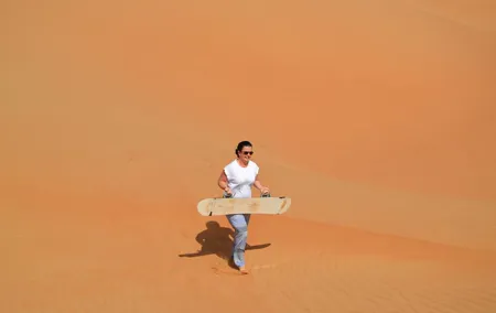 Exclusive Sunrise Desert Safari with Camel Ride Sand Boarding Dune Bashing