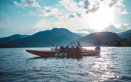 Wine tasting on traditional wooden boats in Wachau Valley