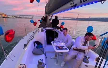 Sunset Sailboat Tour with Guide and Open Bar Green Wine In Lisbon